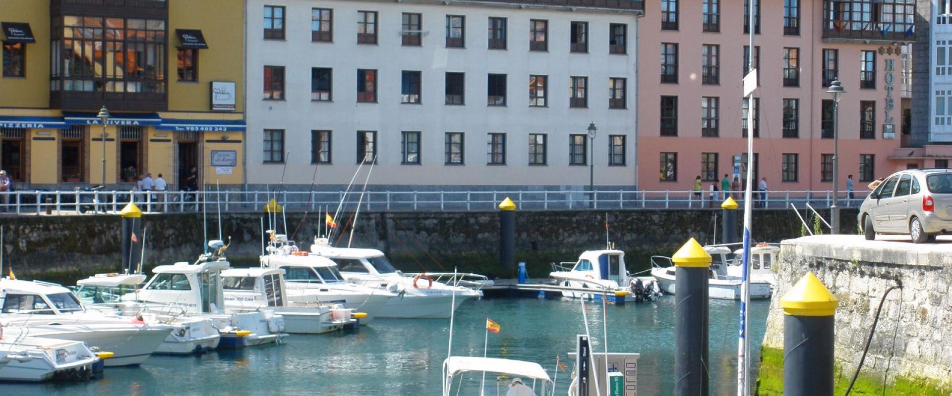Colourful houses and boats in the harbour of Llanes