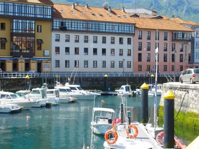Colourful houses and boats in the harbour of Llanes