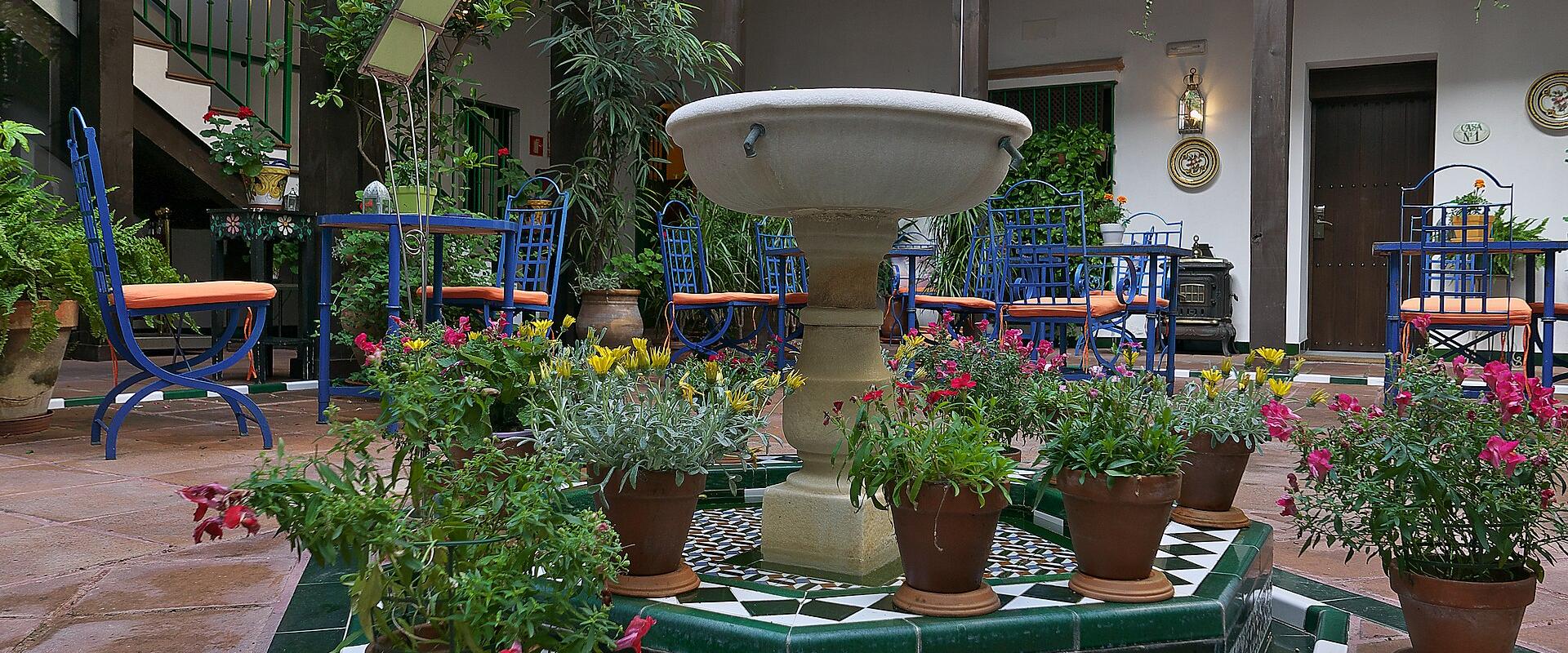 A flower-filled tiled patio in the Barrio de Santa Cruz, Seville