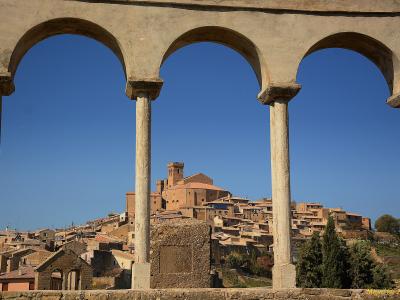 The hilltop village of Ujué seen through a stone arcade