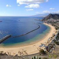 Golden sand of Playa de Las Teresitas curving along a calm blue bay on Tenerife