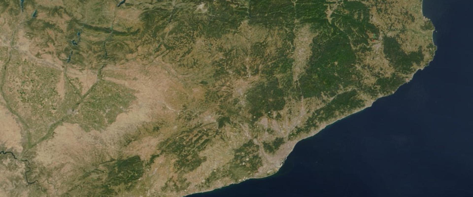 A satellite image showing the northeastern coast of the Iberian Peninsula, with visible mountain ranges, coastal plains, and the Mediterranean Sea, overlaid with black political boundary lines.