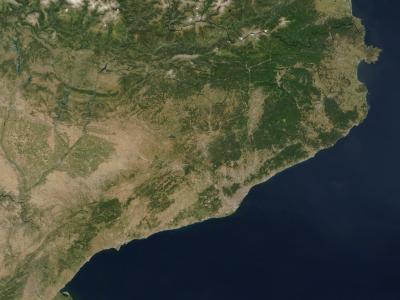 A satellite image showing the northeastern coast of the Iberian Peninsula, with visible mountain ranges, coastal plains, and the Mediterranean Sea, overlaid with black political boundary lines.