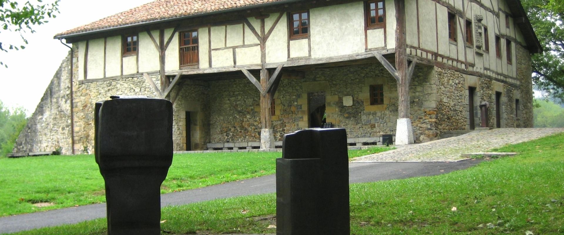 Chillida's iron sculptures on the lawn before the Zabalaga farmhouse at Chillida Leku