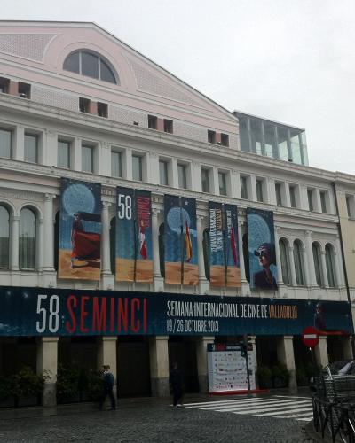 A large, multi-story classical-style building facade adorned with banners for the "58 SEMINCI" film festival, with text identifying it as the "SEMANA INTERNACIONAL DE CINE DE VALLADOLID" held in October 2013.