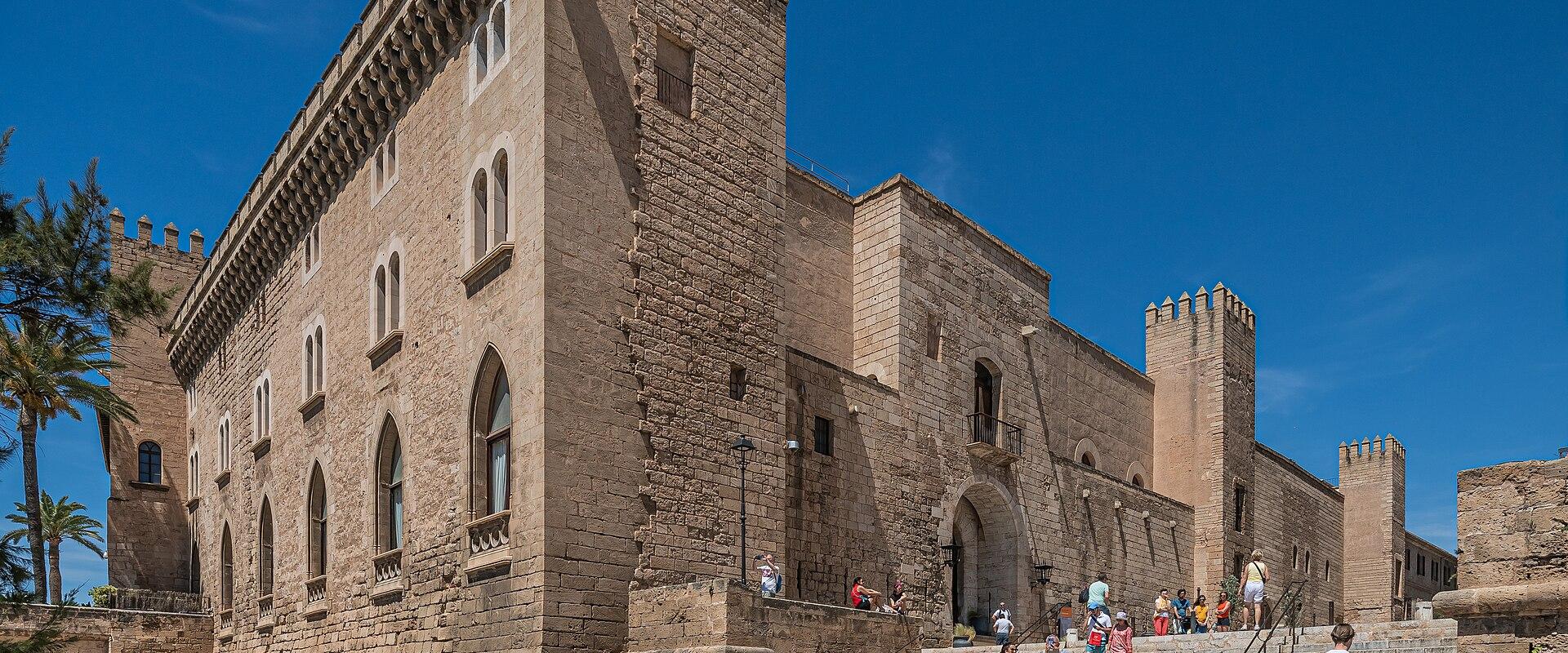 The stone facade of the Royal Palace of La Almudaina above the steps in Palma