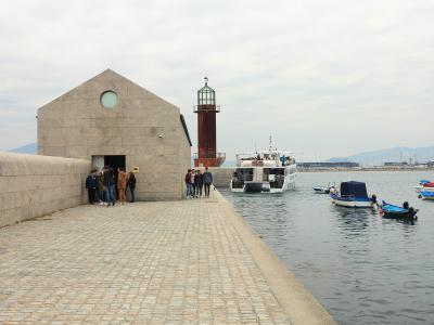 The stone buildings and lighthouse of the Museo do Mar de Galicia on the Vigo waterfront