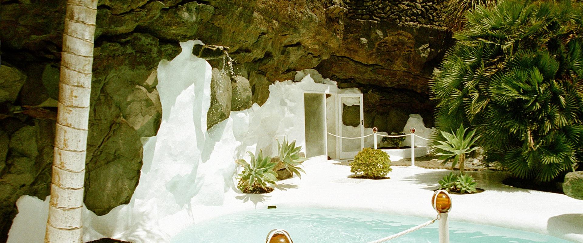White pool and palm inside a lava bubble at the Fundación César Manrique, Lanzarote