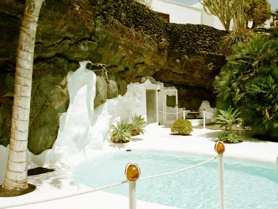 White pool and palm inside a lava bubble at the Fundación César Manrique, Lanzarote