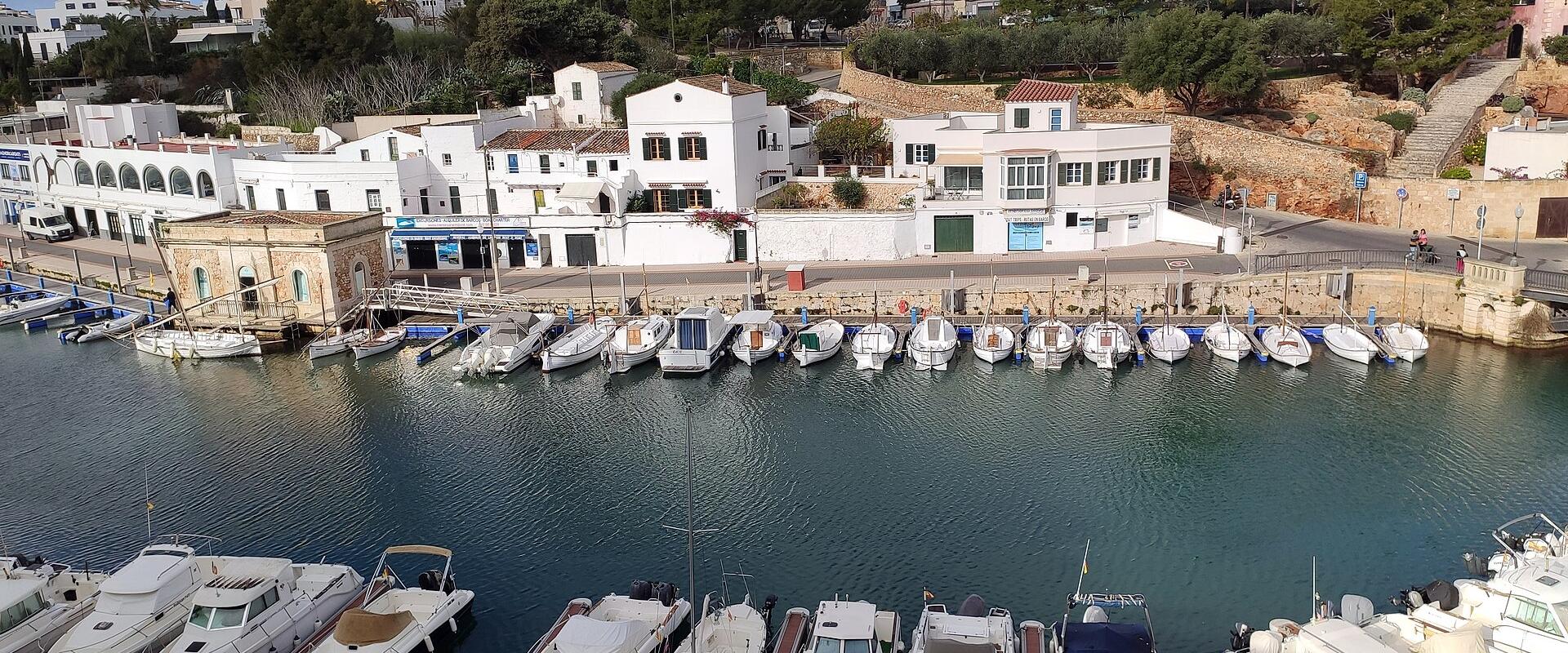 White houses and boats around the harbour of Ciutadella, Menorca