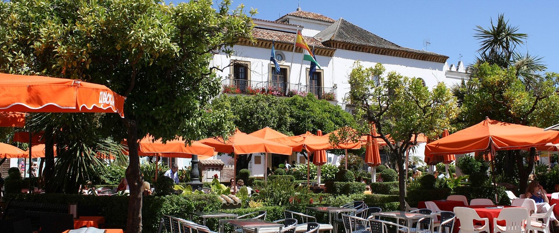 Café tables under orange trees in the Plaza de los Naranjos, Marbella old town