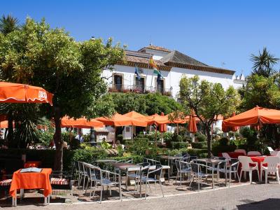 Café tables under orange trees in the Plaza de los Naranjos, Marbella old town